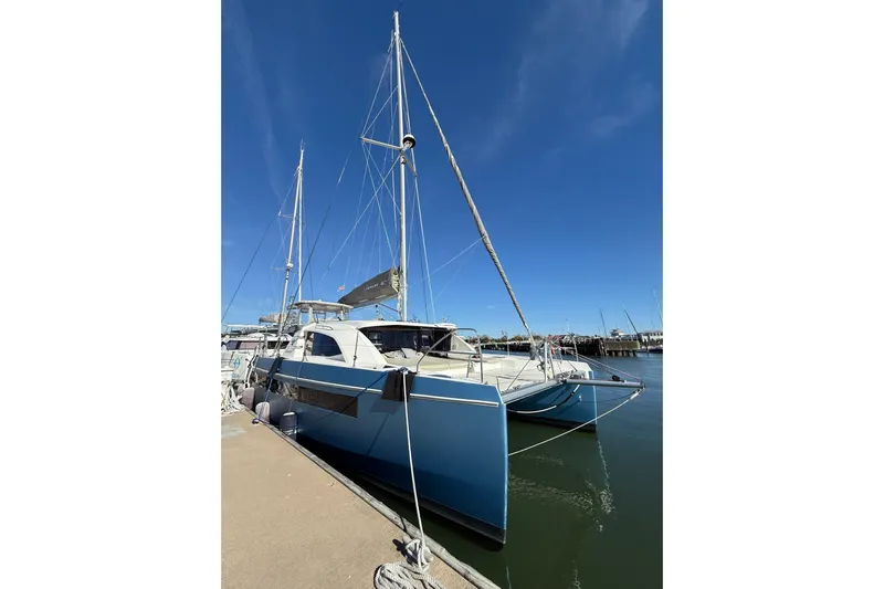 Everything Zen Yacht Photos Pics 2017 Leopard 40 catamaran docked at marina under clear blue sky.