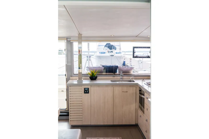 Everything Zen Yacht Photos Pics Modern kitchen interior on 2017 Leopard 40 yacht with sleek cabinetry and window view.