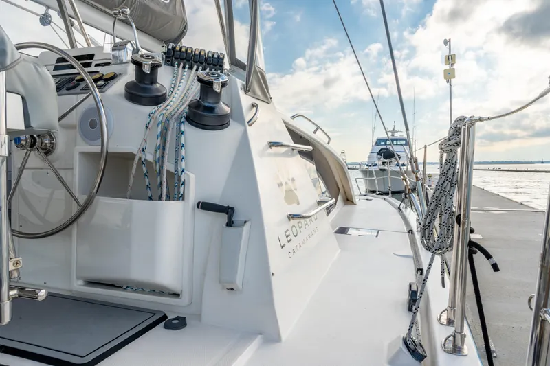 Everything Zen Yacht Photos Pics 2017 Leopard 40 catamaran docked, showcasing helm and rigging under a partly cloudy sky.
