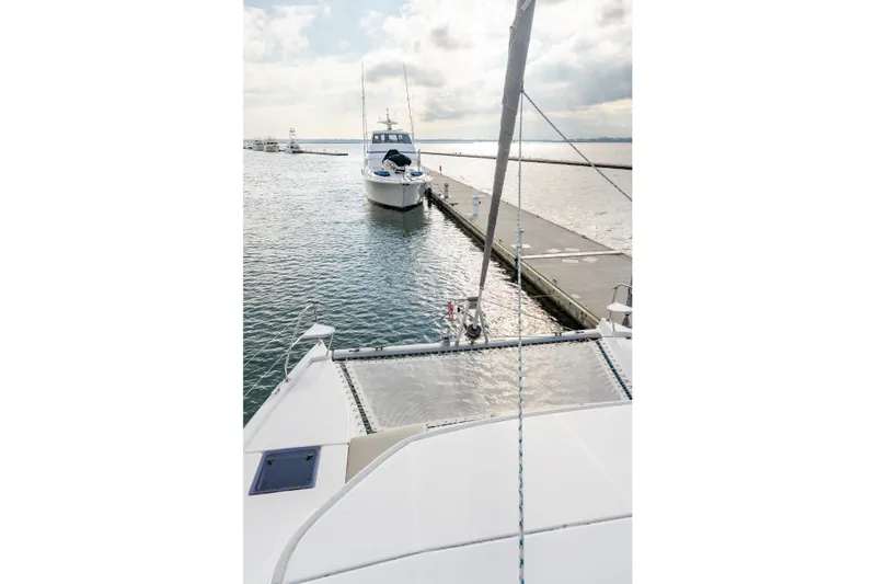Everything Zen Yacht Photos Pics 2017 Leopard 40 catamaran docked at marina, calm waters, overcast sky.