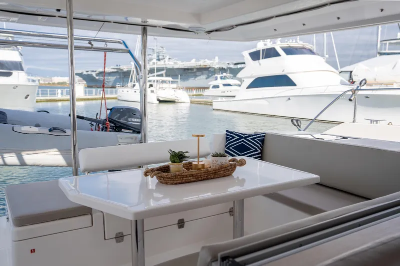 Everything Zen Yacht Photos Pics 2017 Leopard 40 yacht interior with table, cushion, and marina view.