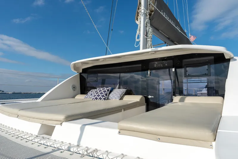 Everything Zen Yacht Photos Pics Luxurious 2017 Leopard 40 catamaran with sunbathing deck and cushions, sailing under clear skies.