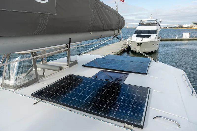Everything Zen Yacht Photos Pics 2017 Leopard 40 catamaran with solar panels docked beside a motor yacht.