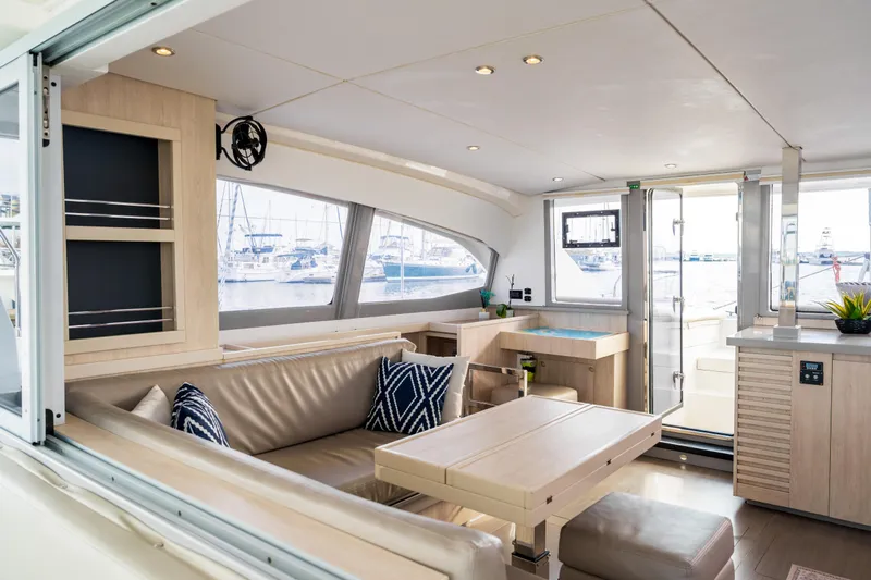 Everything Zen Yacht Photos Pics Luxurious interior of 2017 Leopard 40 catamaran with modern furnishings and marina view.