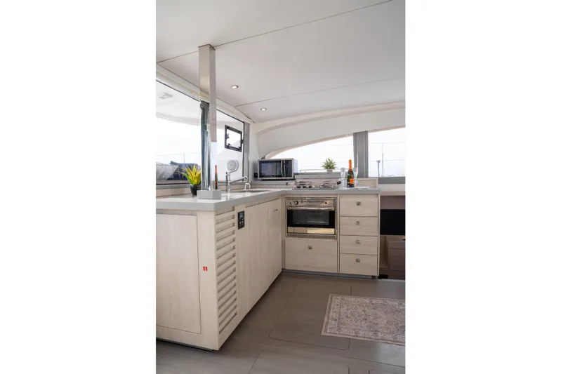 Everything Zen Yacht Photos Pics Modern kitchen interior on a 2017 Leopard 40 yacht, featuring sleek cabinetry and appliances.