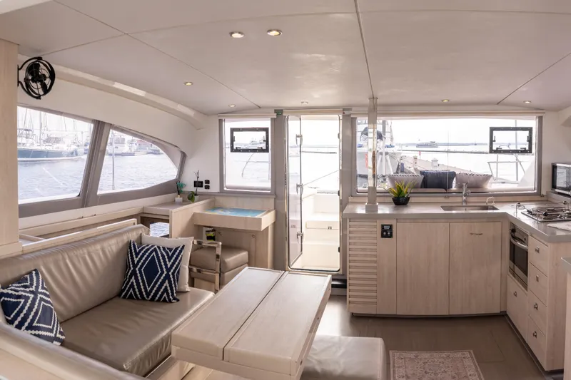 Everything Zen Yacht Photos Pics Luxurious interior of 2017 Leopard 40 catamaran with modern kitchen and seating area.