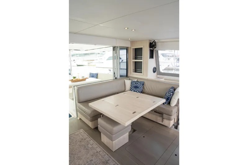 Everything Zen Yacht Photos Pics Interior of 2017 Leopard 40 yacht with modern seating and dining area.
