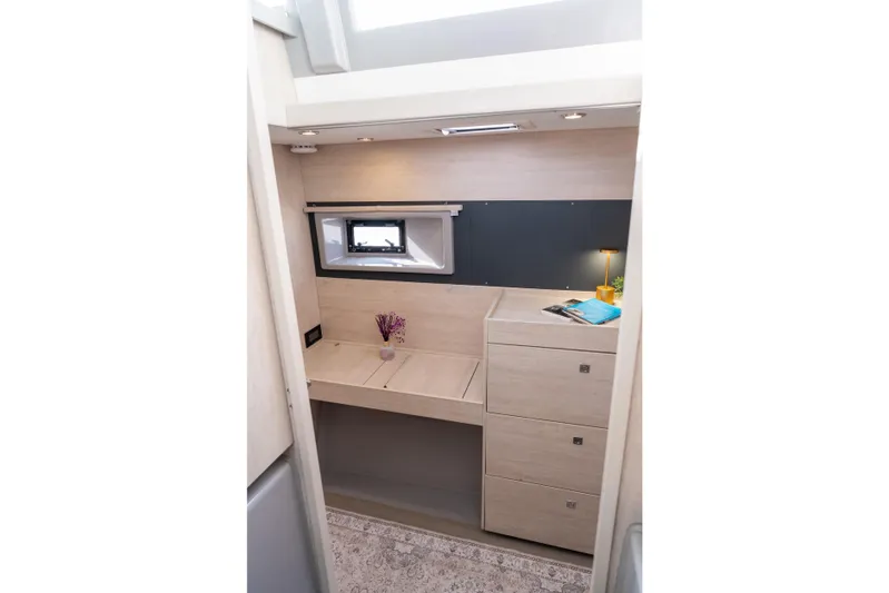 Everything Zen Yacht Photos Pics Interior of 2017 Leopard 40 yacht with desk, drawers, and window.