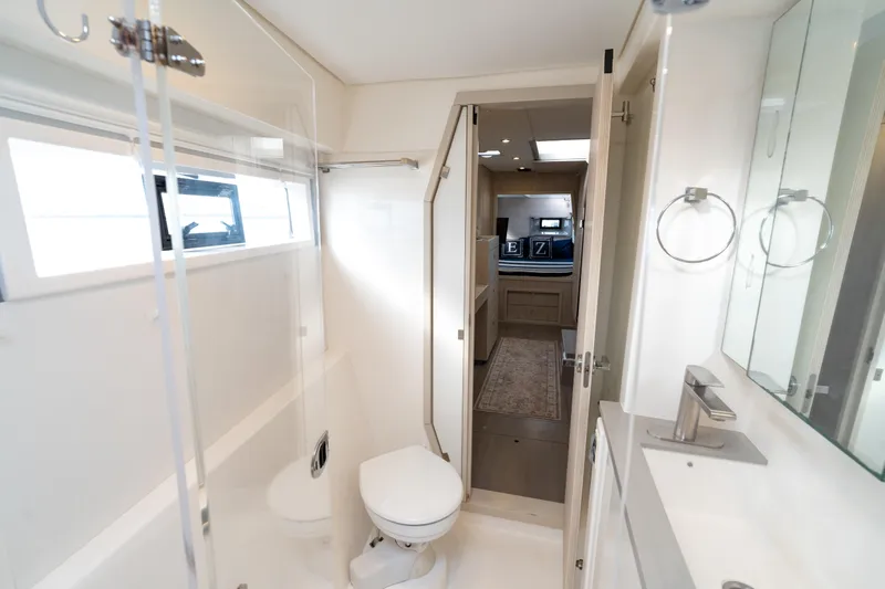 Everything Zen Yacht Photos Pics Modern bathroom interior on a 2017 Leopard 40 yacht, featuring sleek fixtures and ample lighting.