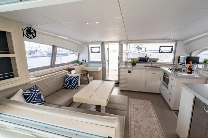 Everything Zen Yacht Photos Pics Luxurious interior of a 2017 Leopard 40 catamaran with modern kitchen and seating area.