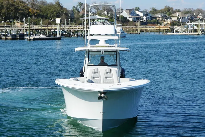  Yacht Photos Pics 2025 Onslow Bay 41 Tournament boat cruising in a scenic harbor setting.