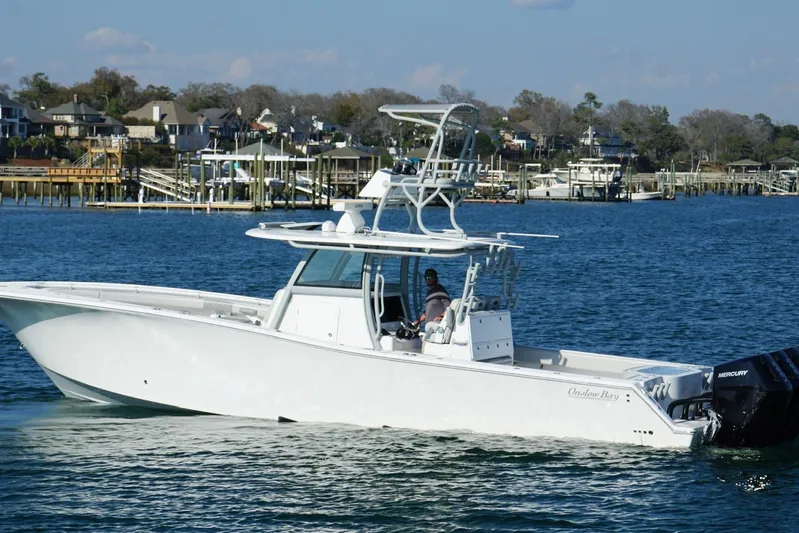  Yacht Photos Pics 2025 Onslow Bay 41 Tournament boat cruising on a scenic waterfront.