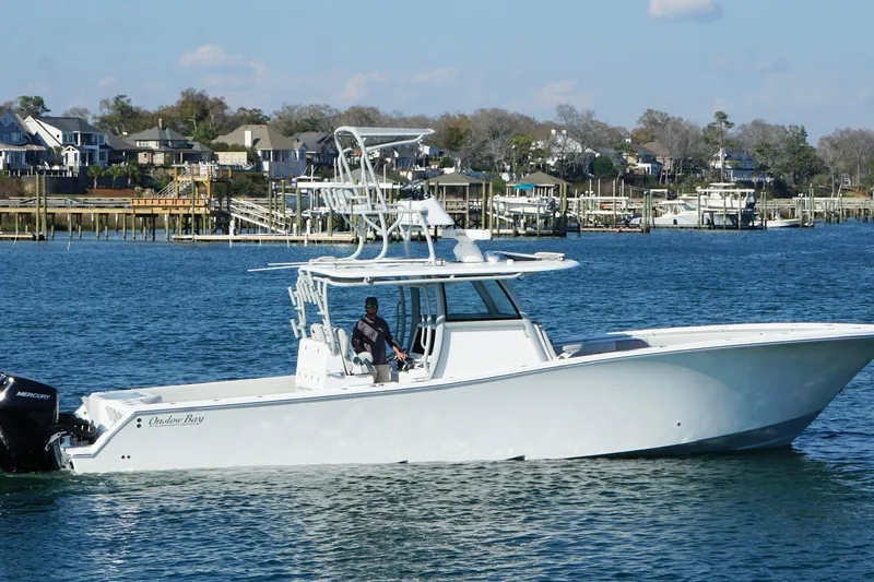  Yacht Photos Pics 2025 Onslow Bay 41 Tournament boat cruising on a scenic waterfront.