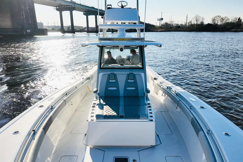  Yacht Photos Pics 2025 Onslow Bay 41 Tournament boat cruising under a bridge on a sunny day.