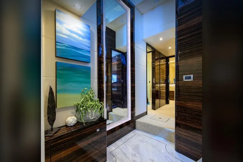  Yacht Photos Pics Luxurious yacht interior with modern decor, featuring abstract ocean paintings and elegant wood finishes.