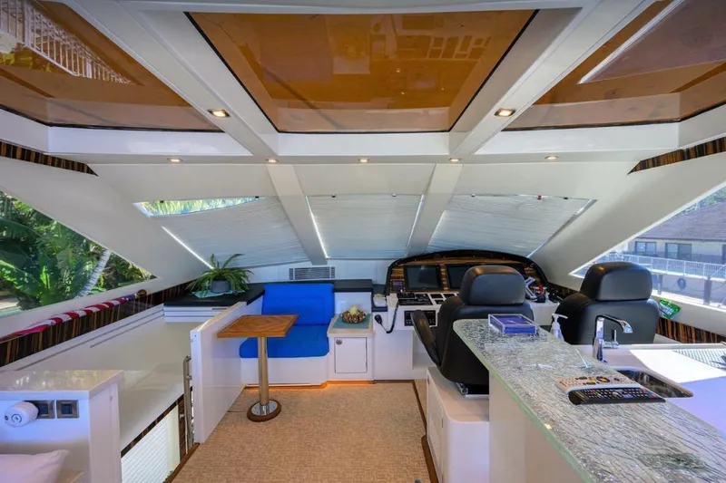  Yacht Photos Pics Luxurious interior of 2014 Hampton Fly yacht with modern helm and seating area.