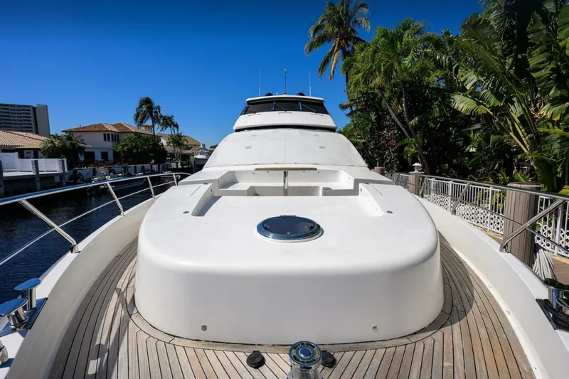  Yacht Photos Pics Luxurious 2014 Hampton Fly yacht docked, surrounded by tropical greenery and waterfront homes.