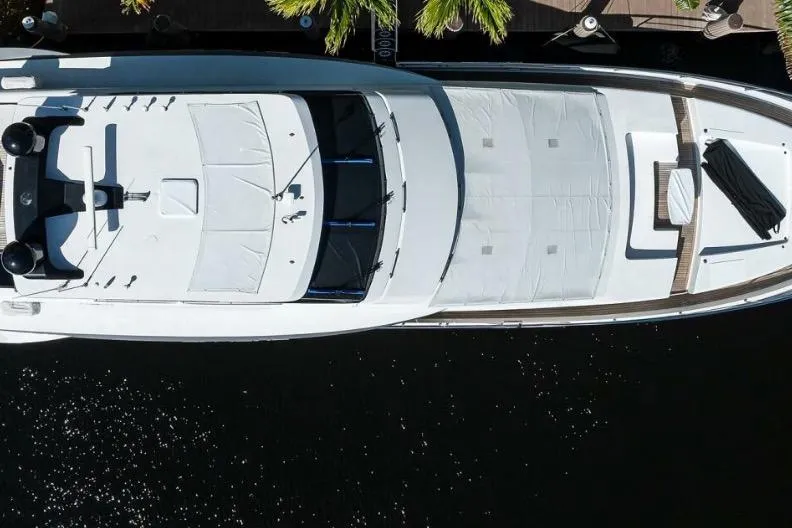  Yacht Photos Pics Overhead view of a 2014 Hampton Fly yacht docked near palm trees.