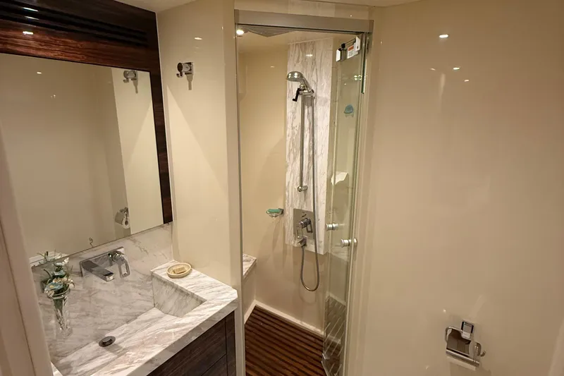  Yacht Photos Pics Luxurious bathroom in 2014 Hampton Fly yacht with marble sink and glass shower.