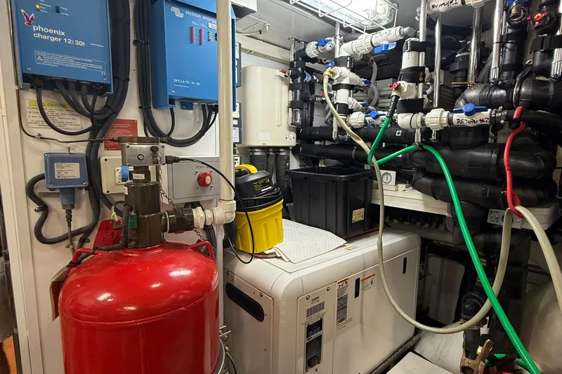  Yacht Photos Pics Engine room of a 2014 Hampton Fly, featuring complex machinery and wiring.