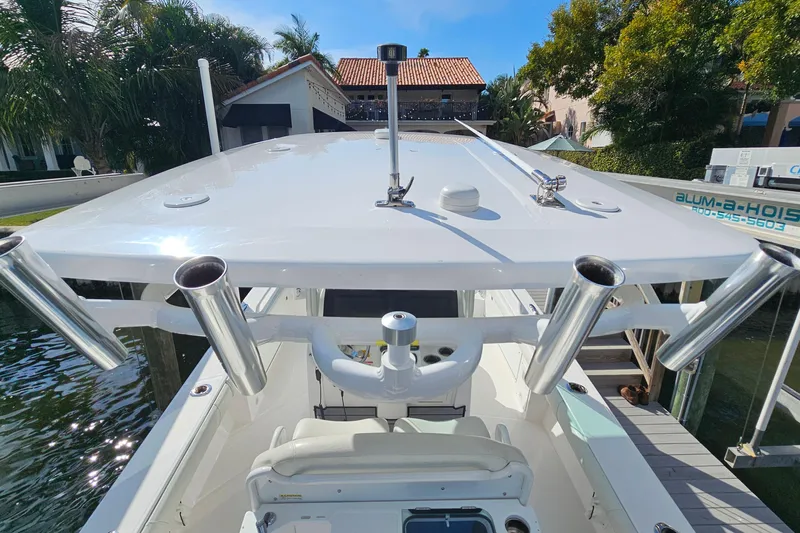  Yacht Photos Pics 2021 Everglades 273 Center Console boat docked, featuring rod holders and sleek design.