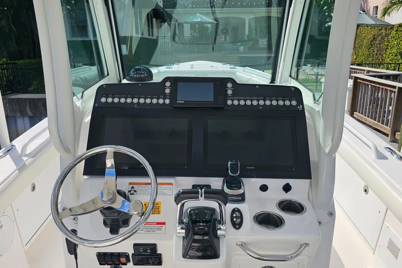  Yacht Photos Pics 2021 Everglades 273 Center Console boat dashboard with steering wheel and navigation controls.