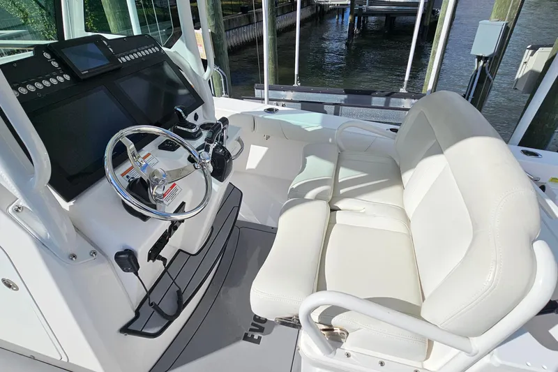  Yacht Photos Pics 2021 Everglades 273 Center Console boat interior with steering wheel and seating.