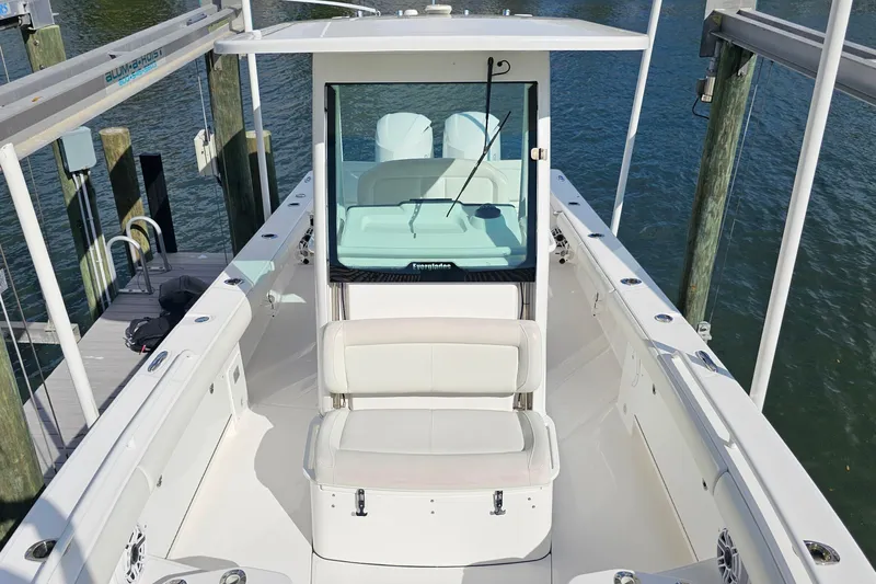  Yacht Photos Pics 2021 Everglades 273 Center Console boat docked, showcasing spacious seating and sleek design.
