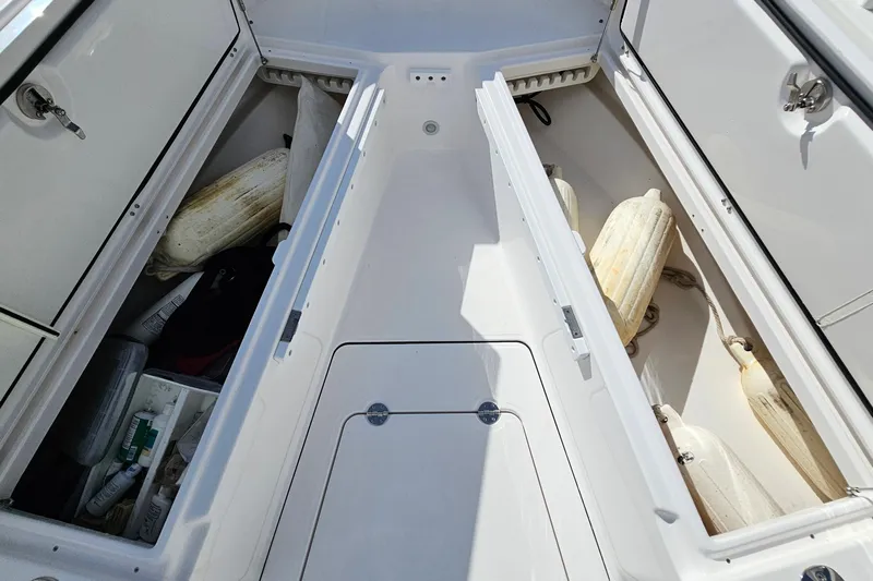  Yacht Photos Pics Storage compartments on a 2021 Everglades 273 Center Console boat, containing fenders and supplies.