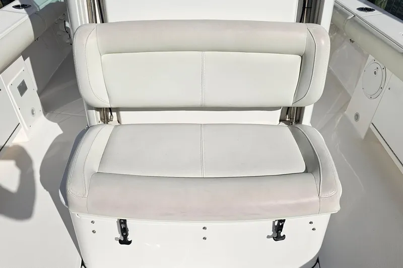  Yacht Photos Pics 2021 Everglades 273 Center Console boat seat, white upholstery, sleek design.