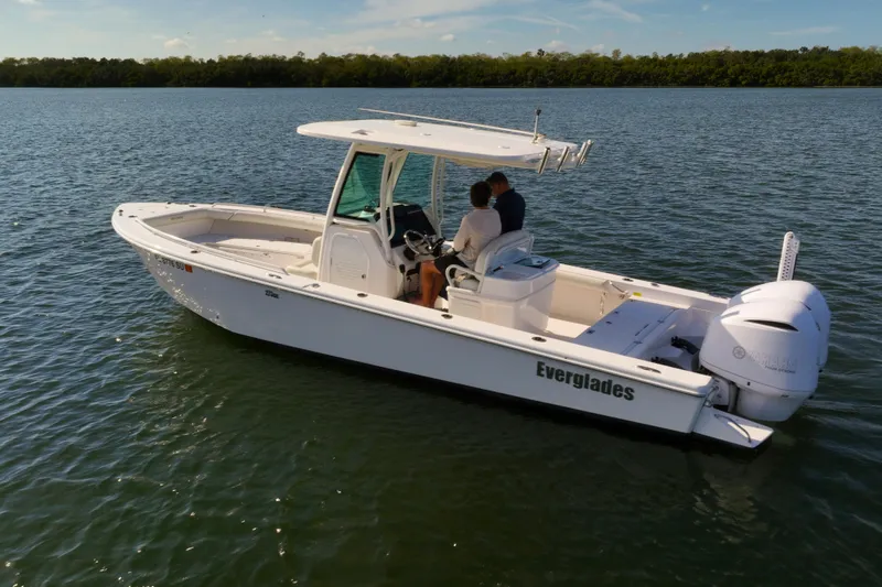  Yacht Photos Pics 2021 Everglades 273 Center Console boat on calm water, featuring sleek design and powerful engine.