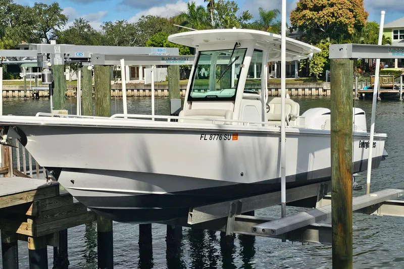  Yacht Photos Pics 2021 Everglades 273 Center Console boat docked on a lift by the waterfront.