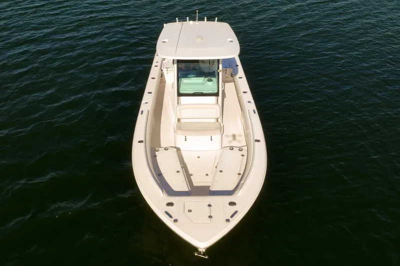  Yacht Photos Pics 2021 Everglades 273 Center Console boat on calm water, aerial view.