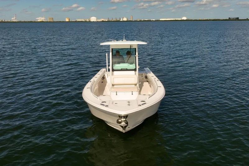  Yacht Photos Pics 2021 Everglades 273 Center Console boat on calm water, clear sky background.