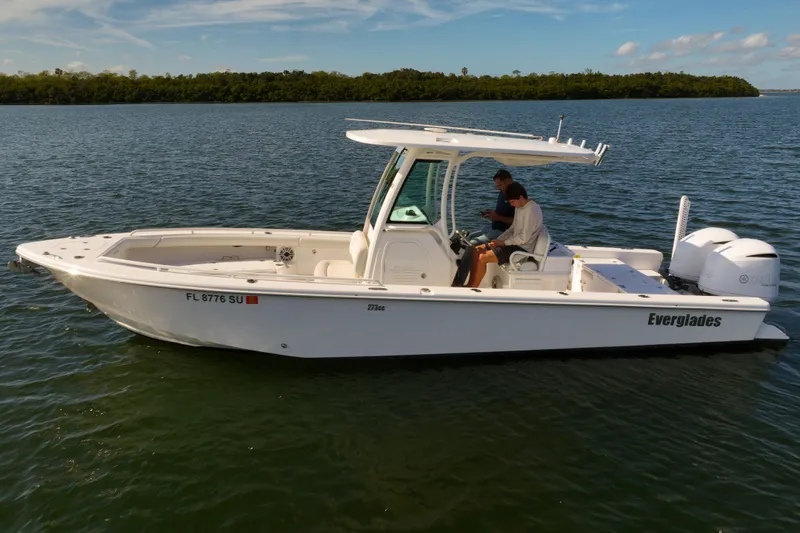  Yacht Photos Pics 2021 Everglades 273 Center Console boat on water, featuring dual engines and sleek design.