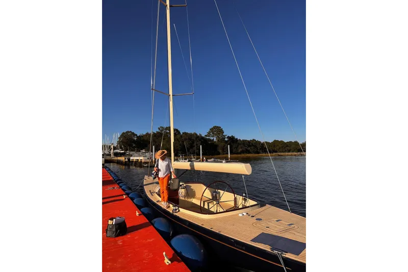  Yacht Photos Pics 2022 Leonardo Yachts Eagle 44 sailboat docked with person on deck.