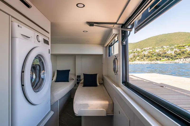 The Absolute Vibe Yacht Photos Pics Interior of 2026 Absolute Navetta 62 yacht with twin beds and washing machine.