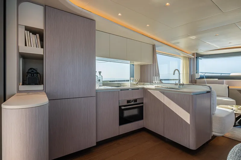 The Absolute Vibe Yacht Photos Pics Luxurious kitchen interior of 2026 Absolute Navetta 62 yacht with modern design and ocean view.