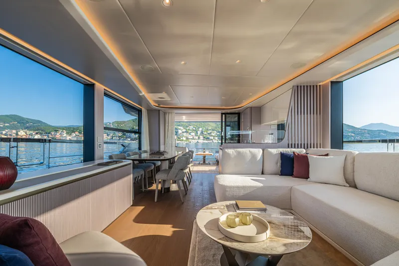 The Absolute Vibe Yacht Photos Pics Luxurious interior of 2026 Absolute Navetta 62 yacht with panoramic windows and elegant furnishings.