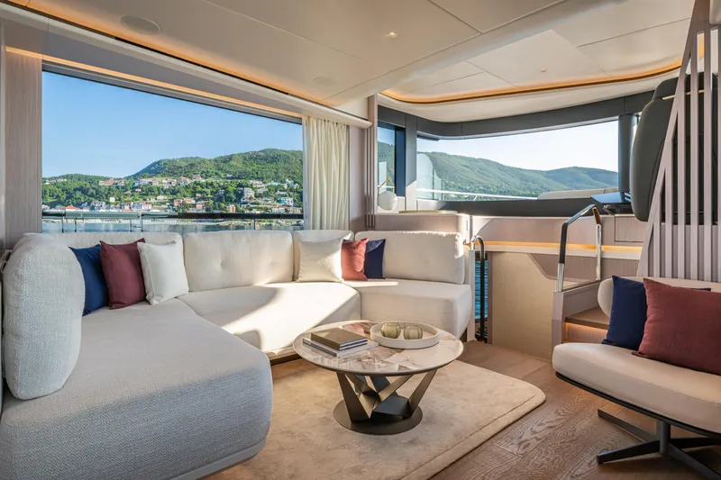 The Absolute Vibe Yacht Photos Pics Luxurious interior of 2026 Absolute Navetta 62 yacht with scenic window view.