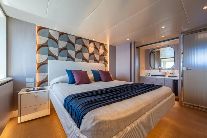The Absolute Vibe Yacht Photos Pics Luxurious bedroom interior on 2026 Absolute Navetta 62 yacht, featuring modern design and elegant decor.