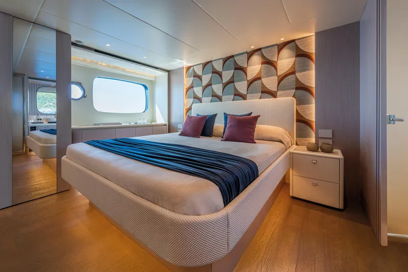 The Absolute Vibe Yacht Photos Pics Luxurious bedroom interior of 2026 Absolute Navetta 62 yacht with modern decor and large window.