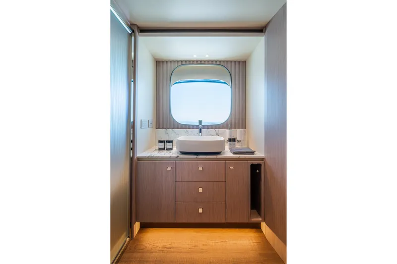 The Absolute Vibe Yacht Photos Pics Luxurious bathroom interior of 2026 Absolute Navetta 62 yacht with modern sink and window.