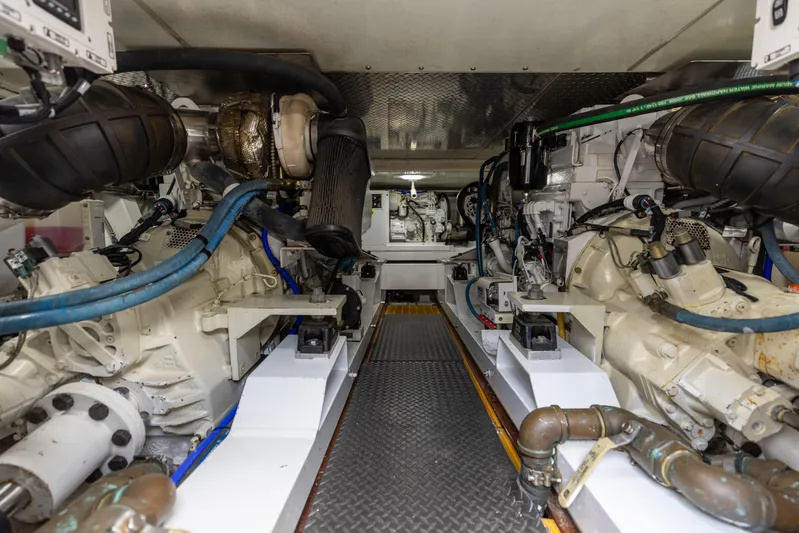 Honcho Yacht Photos Pics Engine room of 2000 Custom Carolina Alex Willis Convertible, showcasing mechanical components and piping.