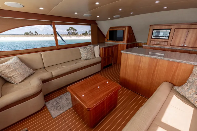 Honcho Yacht Photos Pics Luxurious interior of 2000 Custom Carolina Alex Willis Convertible yacht with elegant wood finishes.
