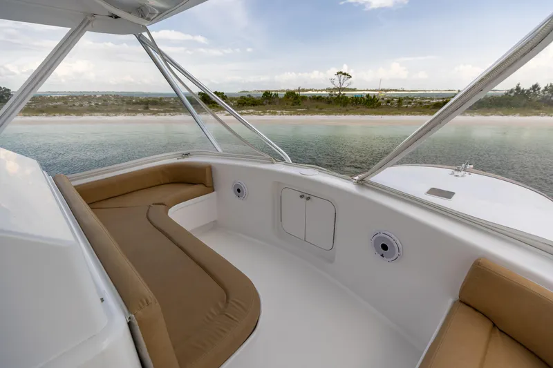 Honcho Yacht Photos Pics Custom Carolina Alex Willis Convertible 2000 boat interior with tan seating, overlooking serene waters.