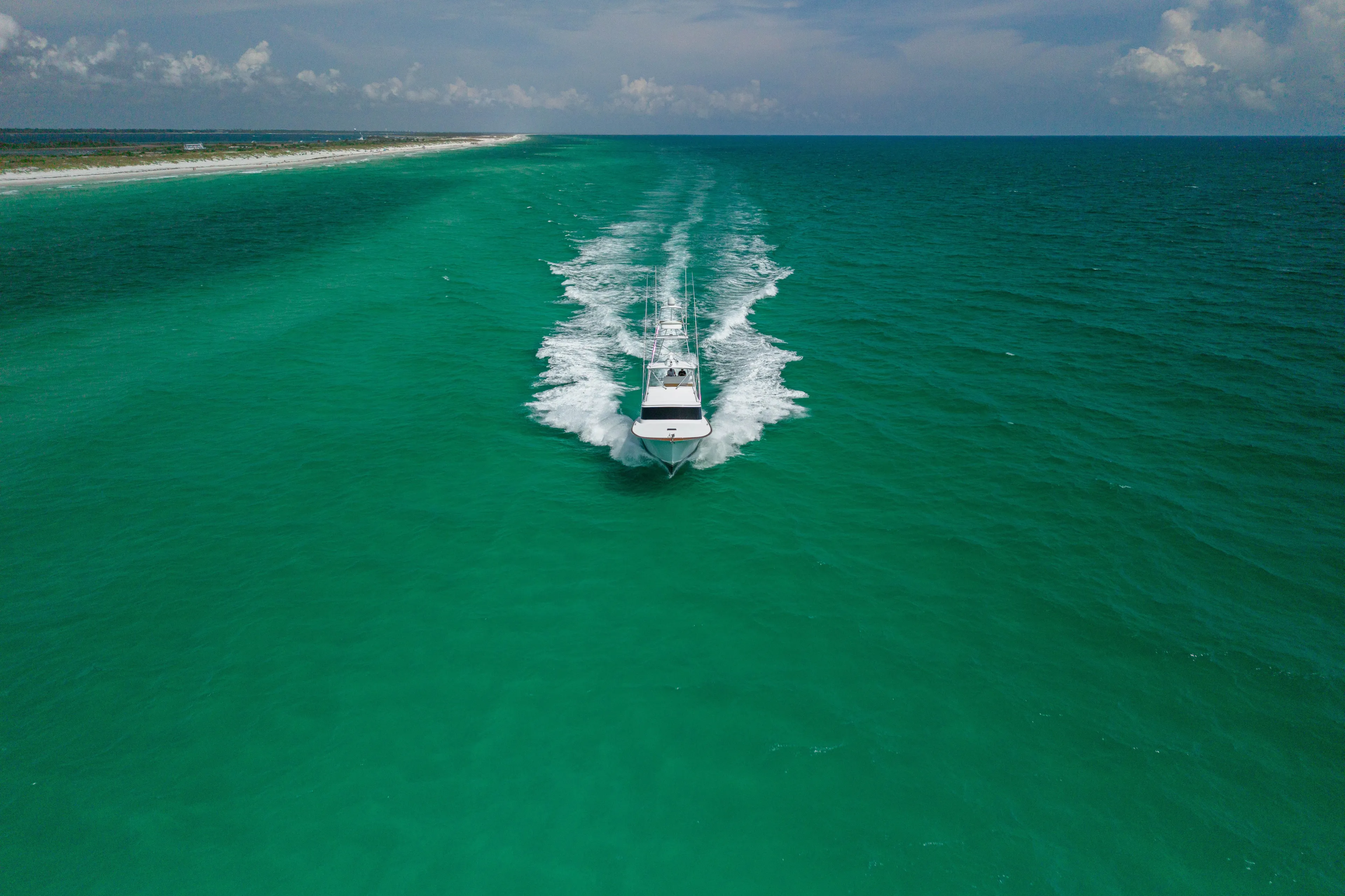 Honcho Yacht Photos Pics Custom Carolina Alex Willis Convertible boat cruising in turquoise ocean waters, 2000 model.