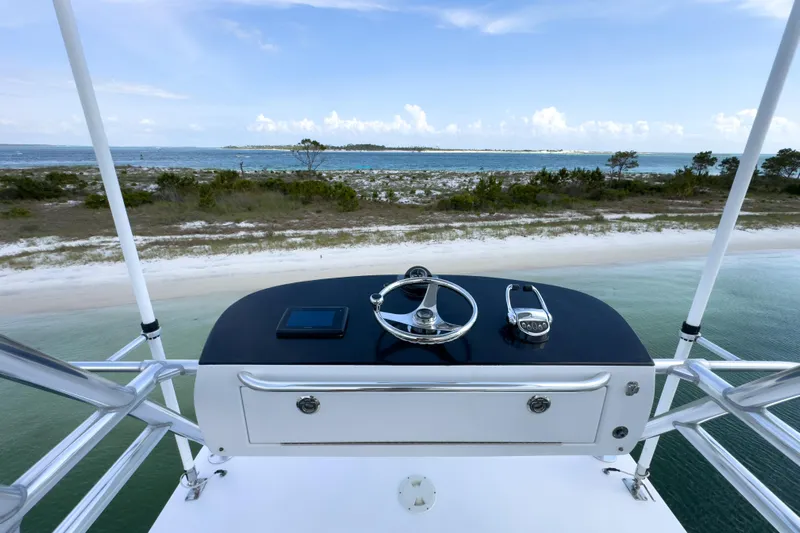 Honcho Yacht Photos Pics Helm view from 2000 Custom Carolina Alex Willis Convertible overlooking serene coastal landscape.