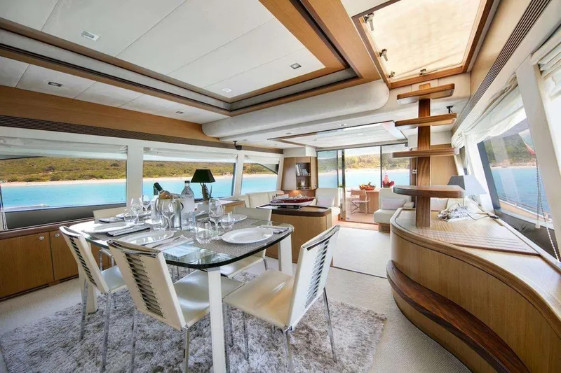  Yacht Photos Pics Luxurious interior of 2005 Ferretti 731 yacht with elegant dining area and scenic ocean views.