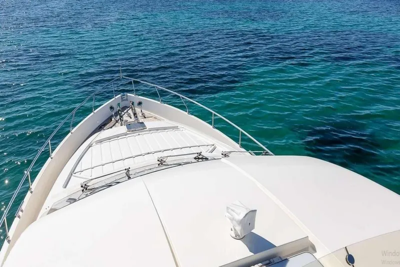  Yacht Photos Pics Bow view of 2005 Ferretti 731 yacht on clear blue water.